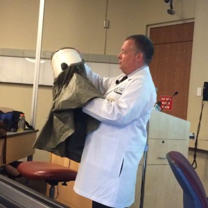 Dr. Douglas Holt demonstrates an option for safety gear when approaching virus Ebola. Holt, who works as the director of the Division of Infectious Disease and Internal Medicine at USF, recognizes the virus as deadly but not easily contagious.