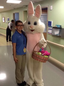 Courtney Thompson, who volunteers at All Children’s Hospital, poses with a costumed bunny during a visit.