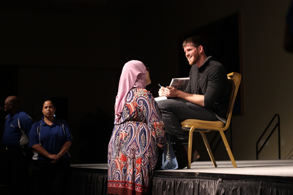 Devin Rodriguez / Crow’s Nest  Brandon Stanton, founder of the popular storytelling blog Humans of New York, took questions from the crowd after his lecture at USF Tampa on April 6. Here he signs his book for a fan.