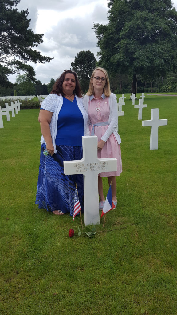 Remembering Leo: USFSP graduate student Deborah Pettingill and Konner Ross stand at Leo K. Chalcraft’s grave in the Normandy American Cemetery in France. As a part of a National History Day project, Ross (right) wrote a eulogy to honor Chalcraft.