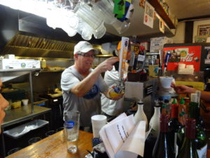 Football Family: Tom Herzhauser pours a Bayboro Blonde ale. Herzhauser’s son Joe played offensive line for USF, his jersey hangs on the wall. The Tavern plans to open Saturdays to show college football games. New food, drinks and games will be offered. 
