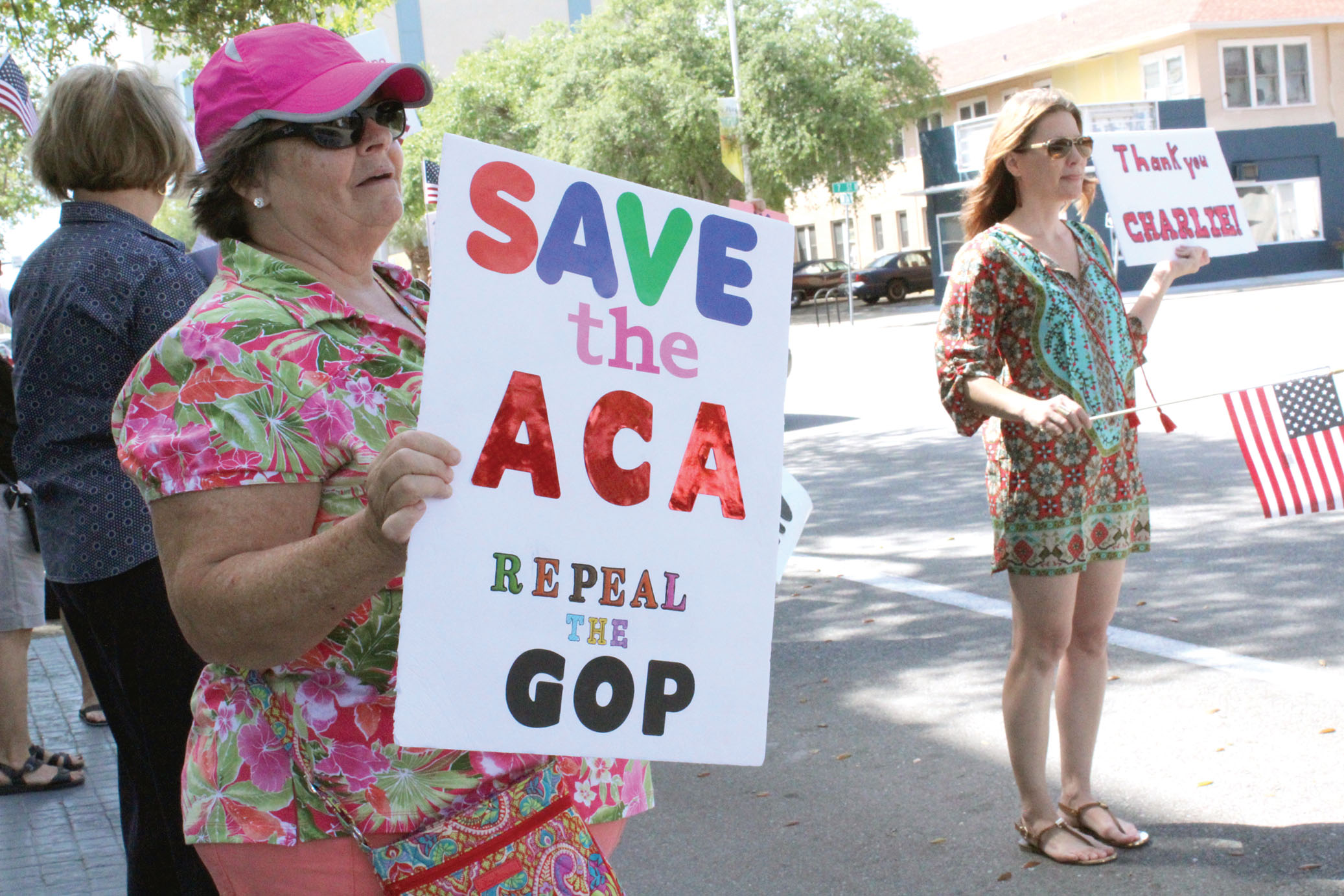 Indivisible Activism: Jean Nelson (left) and Sandra Acton (right) hold signs in front of Rep. Charlie Crist's office on Friday, March 24. Nelson., Acton and other members of Indivisible FL-13 met there to rally and thank Crist for promising to vote against the American Health Care Act. Nicole Carroll | The Crow's Nest