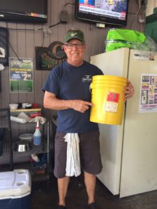 Lord of Flies: Tavern owner Tom Herzhauser holds up a five gallon bucket, similar to the one he used to solve the summer fly problem. Timothy Fanning | The Crow’s Nest
